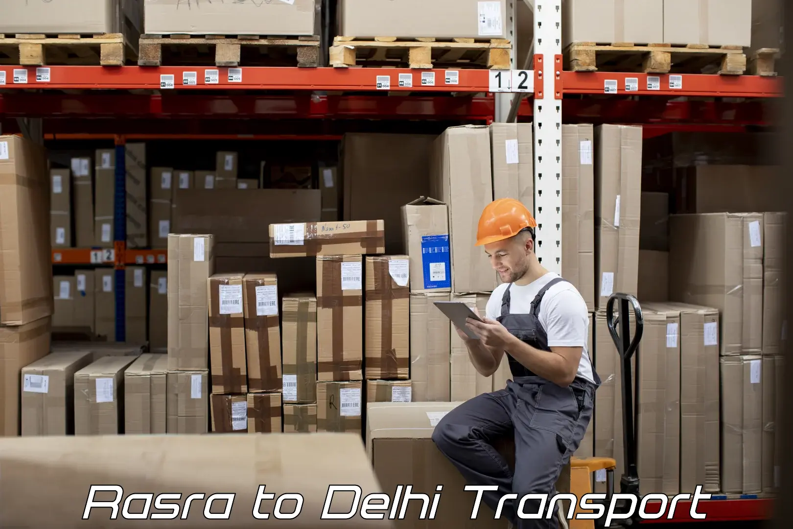 Two wheeler transport services Rasra to Delhi